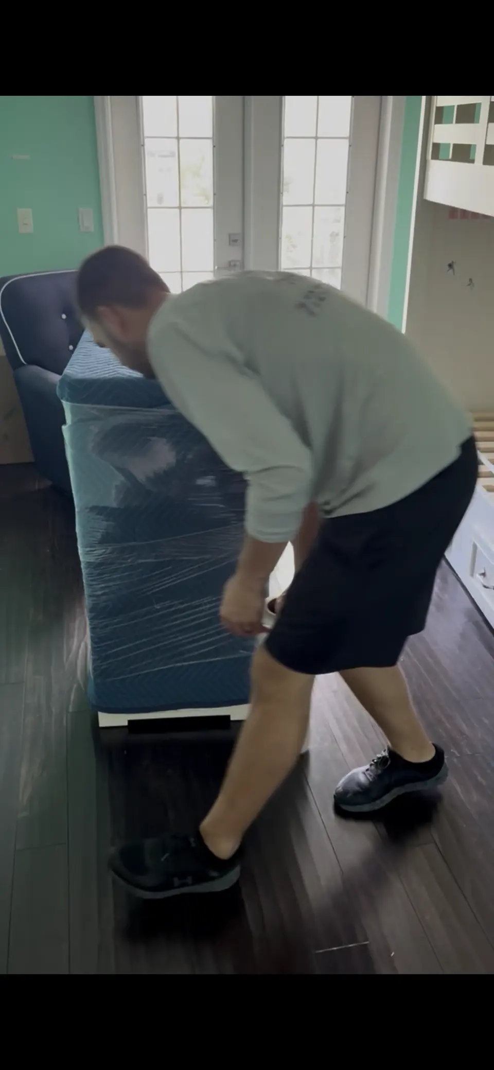 Andersen Moving crew shrink-wrapping furniture during a residential move