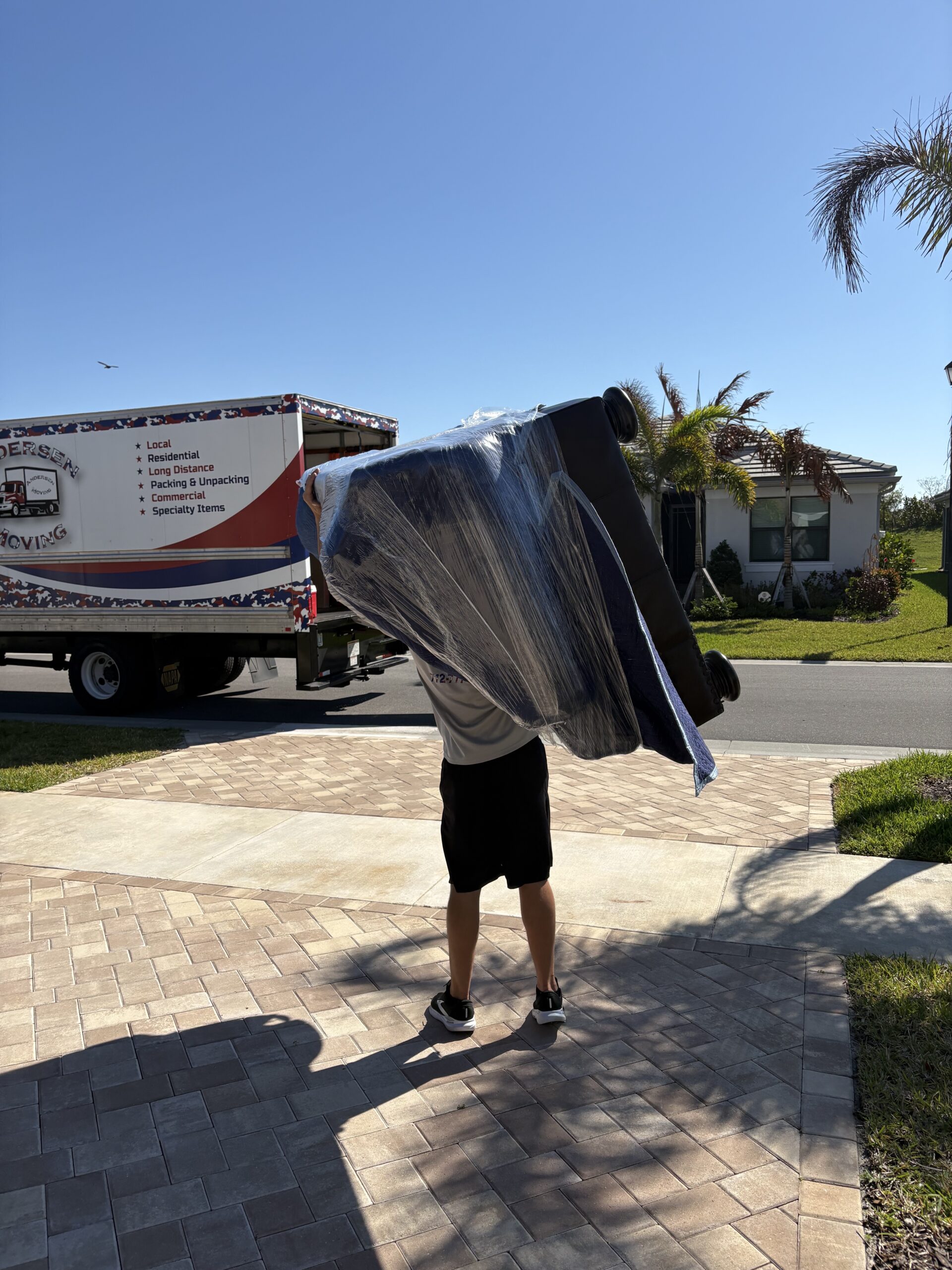 port st. lucie mover carrying couch